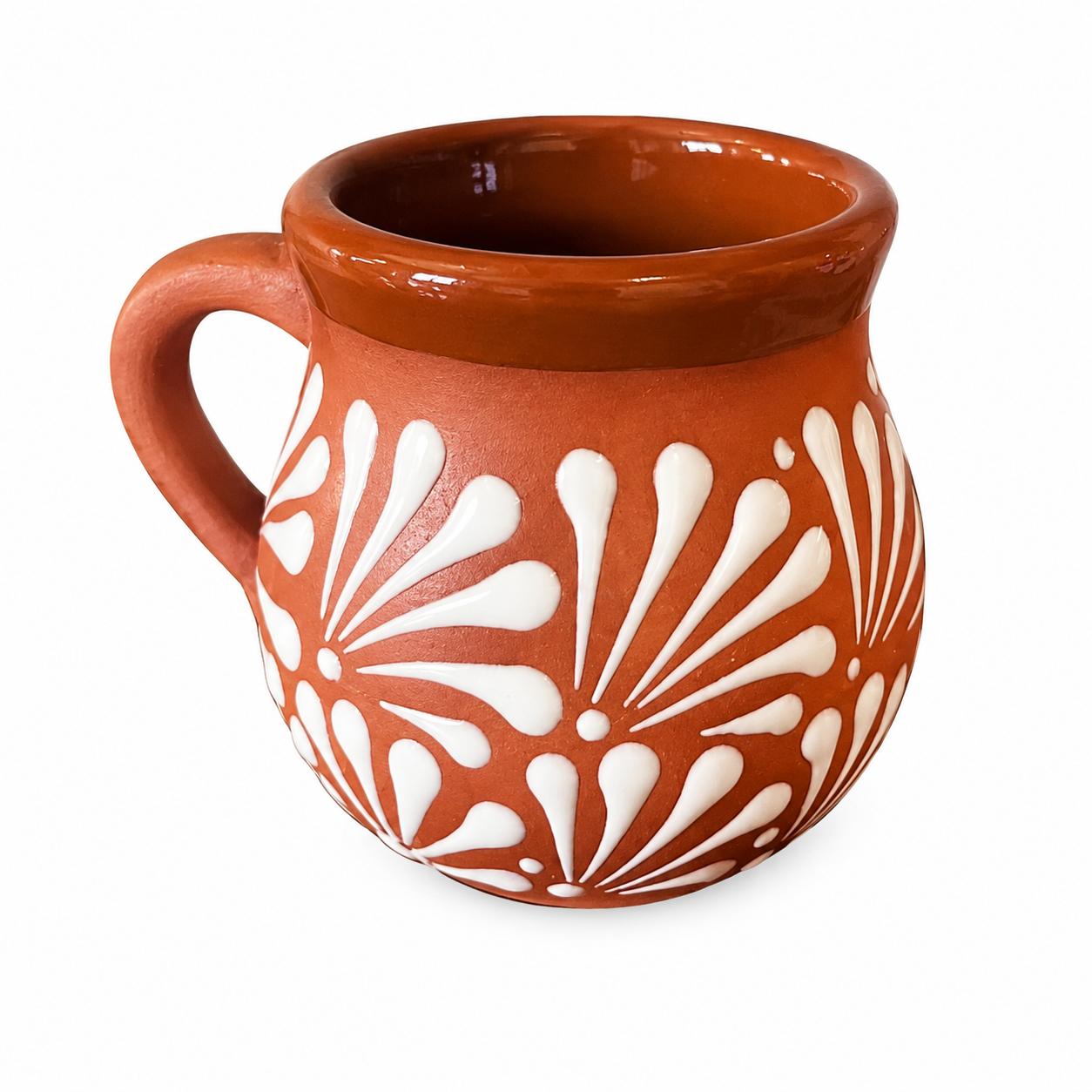 Ceramic mug with white floral patterns on a white background