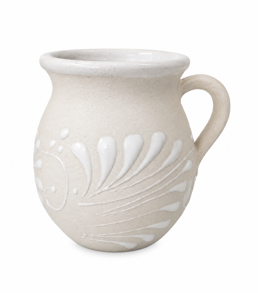 White ceramic mug with decorative patterns on a white background