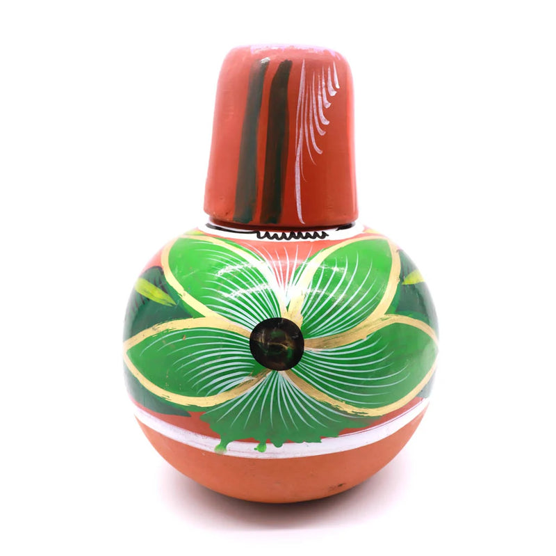 A hand-painted ceramic bottle with a terracotta-colored body and cap, decorated with a large green flower motif outlined in gold and accented with white lines, on a white background.