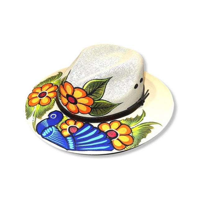 Colorful hand-painted hat with flowers and a bird design on a white background